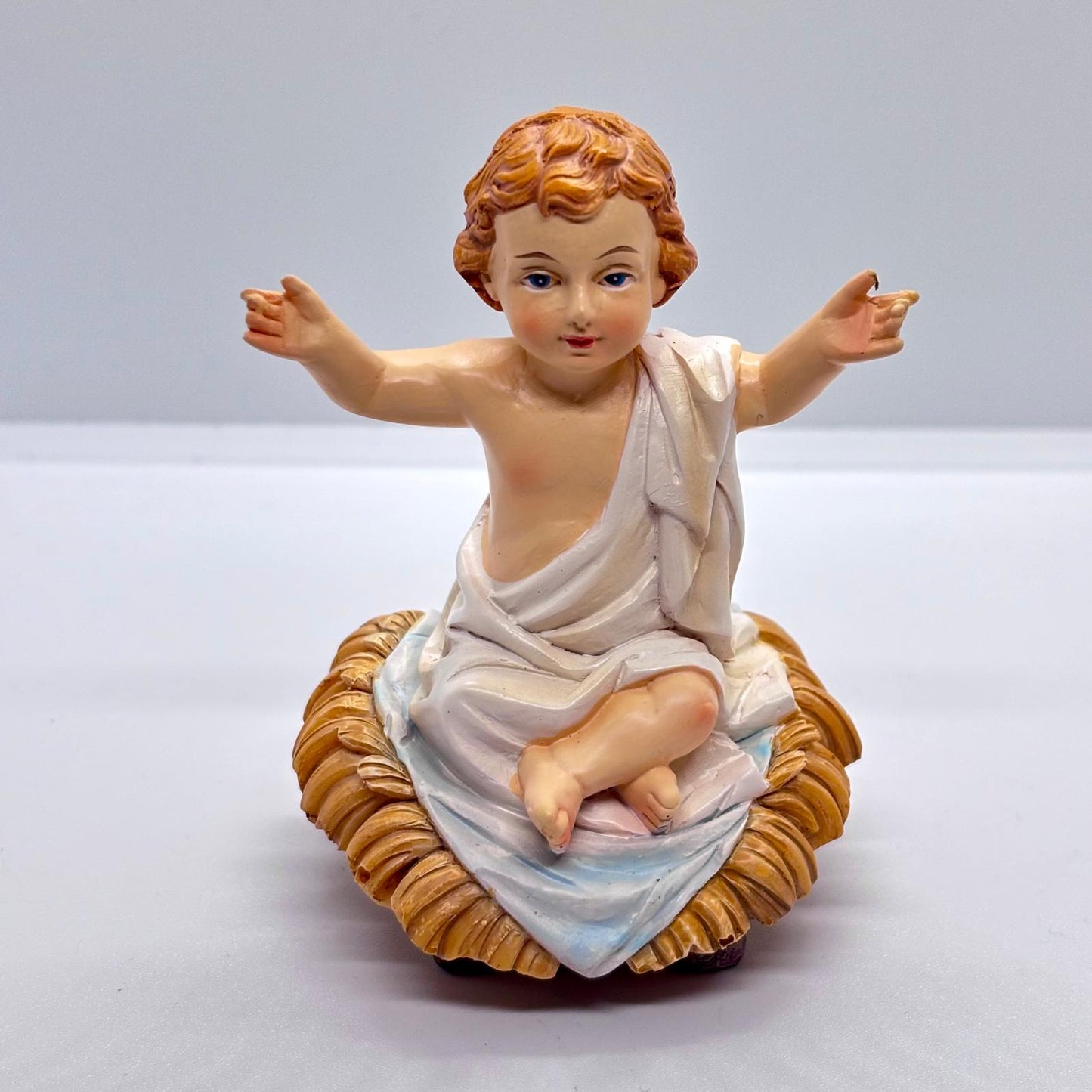 Bambin Gesù seduto su mangiatoia